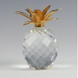 A Swarovski Crystal glass and gilt paperweight in the form of a pineapple 10cm, boxed (no