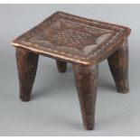 An Eastern square carved hardwood stool raised on tapered supports 23cm h x 28cm w x 25cm d