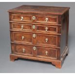 A Queen Anne oak chest of 4 long drawers with original brass pin drop handles, crowned brass