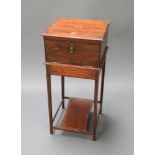 An Edwardian inlaid mahogany dressing cabinet, the hinged lid fitted a mirror above fall front,
