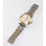 A lady's steel cased Tissot calendar wristwatch on a bimetallic bracelet