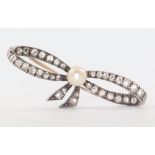 An Edwardian yellow metal diamond and seed pearl bow brooch 40mm, 3 grams