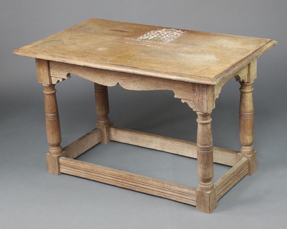 An 18th Century style oak side table, raised on turned supports with box framed stretcher, marked