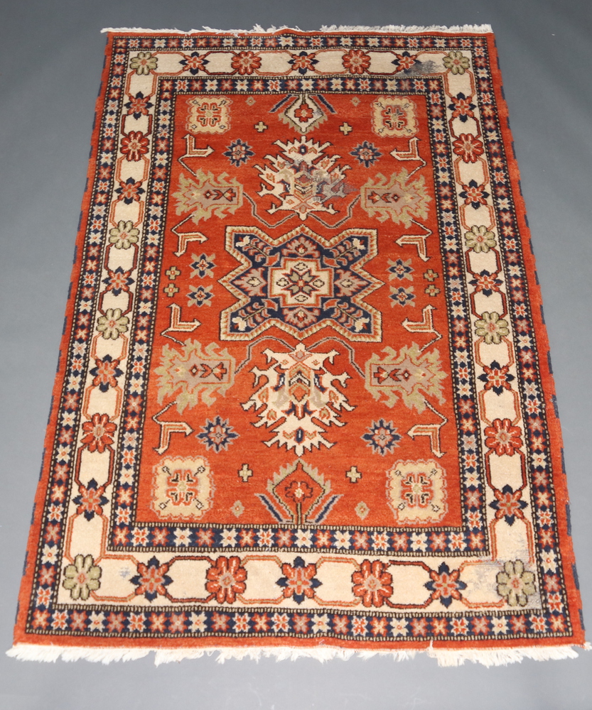 A yellow, orange and blue ground Afghan rug with central medallion within a multi row border 244cm x