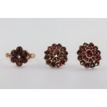 A yellow metal garnet set ring size L, a pair of ditto ear studs