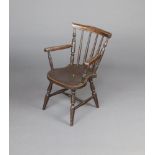A child's 19th Century painted pine stick and rail back open armchair with H framed stretcher, on