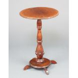 A Victorian circular mahogany wine table raised on a bulbous turned column and circular base with