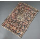 A pink, blue and white ground Persian rug with central medallion within a multi row border 128cm x
