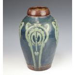A Brannam Barum style tapered cylindrical vase decorated with geometric patterns on a blue ground
