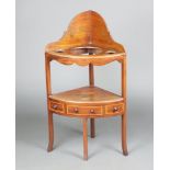 A Georgian inlaid mahogany corner wash stand, the upper section with 3 bowl receptacles, raised on