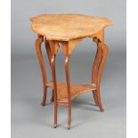 An Art Nouveau Liberty style bleached oak 2 tier occasional table of serpentine outline, raised on