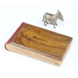 A metal novelty tape measure in the form of a donkey with winder tail together with a Jerusalem