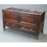 A 17th Century oak mule chest with hinged lid, the foliate carved frieze inscribed AH 1700, the base