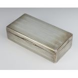 A rectangular silver engine turned cigarette box London 1919 18cm There are numerous scratches and