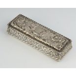 An Edwardian silver repousse rectangular trinket box with vacant cartouche and floral decoration