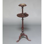 A 1930's turned mahogany 2 tier smoker's stand, the top fitted a brass ashtray, the lower section