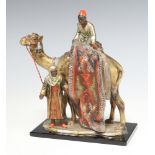 After Bergman, a cold painted spelter table lighter in the form of a rug vendor with camel, raised