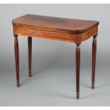 A Georgian inlaid and crossbanded mahogany D shaped card table, raised on turned and reeded supports