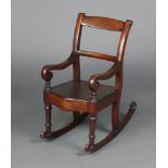 A child's 19th Century mahogany bar back rocking chair with solid seat of serpentine outline 64cm