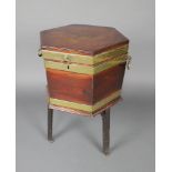 A Georgian hexagonal brass banded mahogany wine cooler with lid and fitted interior, raised on