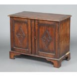 A carved oak cabinet formed from old timber, the top formed from 4 planks, raised on bracket feet