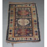 A blue, brown and white ground Caucasian rug with 3 octagons to the centre 141cm x 102cm In wear,