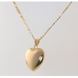 A yellow metal 585 necklace and heart pendant, a yellow metal 9ct necklace heart pendant, cross