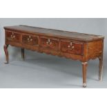 A 17th Century oak dresser base, the top formed from 3 planks fitted 4 drawers with steel locks,