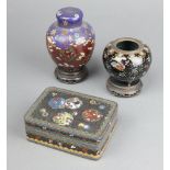 A rectangular black ground and floral patterned cloisonne enamelled jar and cover 4cm x 10cm x