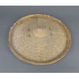 An African circular hide and wooden shield 35cm diam.Handle to interior missing and chips in places