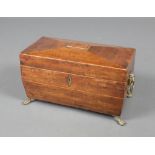 A Georgian inlaid mahogany tea caddy of sarcophagus form with brass ring drop handles raised on