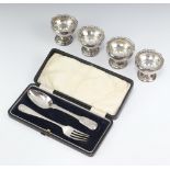 A set of 4 Victorian silver pedestal salts Birmingham 1892 and a silver fork, 166 grams