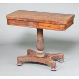 A William IV rosewood D shaped card table raised on a turned column and triform base ending in bun