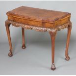 A 1930's Queen Anne style figured walnut card table of serpentine outline, raised on cabriole