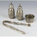 A pair of Victorian repousse silver peppers Birmingham 1890, a mustard and a pair of sugar nips