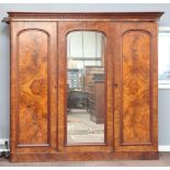 A Victorian figured walnut triple wardrobe with moulded cornice, 1 section fitted 3 drawers above