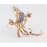A 9ct yellow gold brooch in the form of an exotic bird set with sapphires and rubies, 4.7 grams,