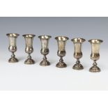 A set of 6 white metal Kiddish cups with engraved floral decoration, London import marks 1902, 202