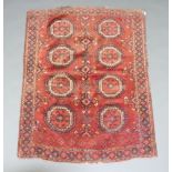 A red and blue ground Afghan rug with 8 octagons to the centre within a multi row border 147cm x