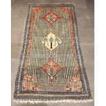 A white, blue and orange ground Western Persian rug, the centre with 3 medallions, the central