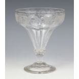 A 19th Century drinking glass with engraved vinous decoration and ring stem with spread foot base