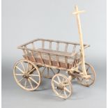 A 19th Century child's wooden pull along cart with iron shod wheels 54cm h x 76cm l x 46cm w There