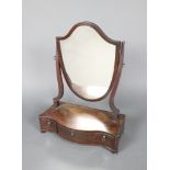 A 19th Century shield shaped plate dressing table mirror contained in a mahogany frame, raised on