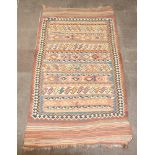 A blue, tan and white ground Kilim rug with all over geometric design 282cm x 146cm In wear, 2