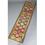 A black, green and orange ground Maimana Kilim runner with geometric design 297cm x 82cm