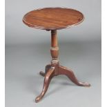 A 19th Century circular mahogany dish and snap top wine table, raised on a turned column and