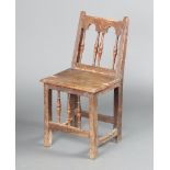 A 17th Century carved oak bar and rail back chair with turned yew spindles, solid seat raised on