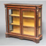 A Victorian ebonised and amboyna display cabinet, fitted shelves enclosed by a pair of arch panelled