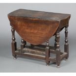A 17th/18th Century oval oak drop flap gateleg tea table, formerly fitted a drawer, raised on turned
