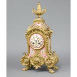 A 19th Century French 8 day timepiece contained in a gilt metal and pink porcelain case with Roman